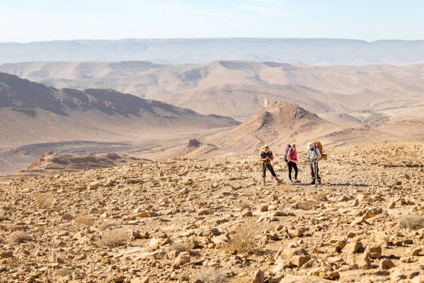 istock Three backpackers standing mountains trail , Negev desert,  Israel. 923752496