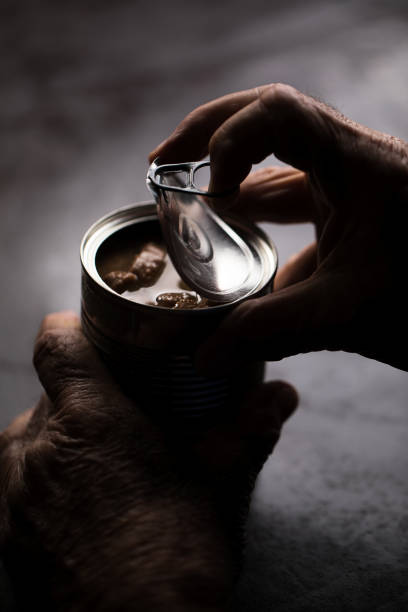 istock Senior opening a can of food 923752810