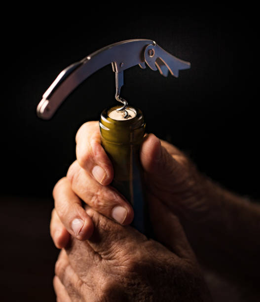 istock Senior man opening a wine bottle 923753198