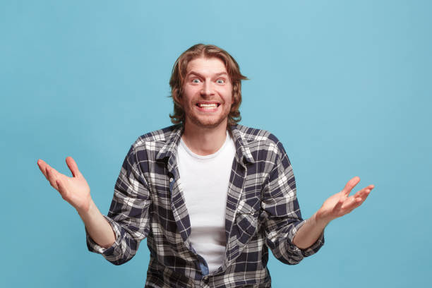 istock Beautiful man looking suprised isolated on blue 923753552