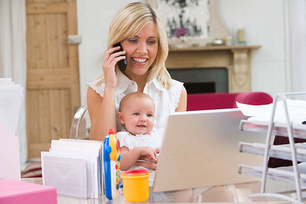 istock A happy mother with her baby working at a home office 92375628