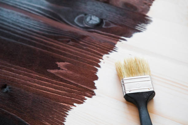 istock Brush on wooden background, Board half painted 923757168