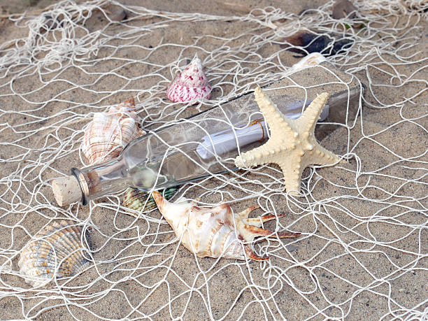 istock Bottle with message in the fishing net 92375772