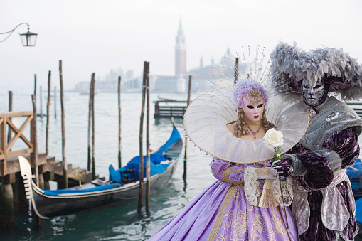 Venice, Italy - February 21, 2022: The Carnival of Venice, when visitors and residents of Venice dress up in wonderfully elaborate costumes and parade through the squares and along the banks of the canals.