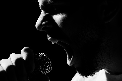 Concert singer close-up.  High contrast spot lighting.  Some minor noise, but lots of detail.