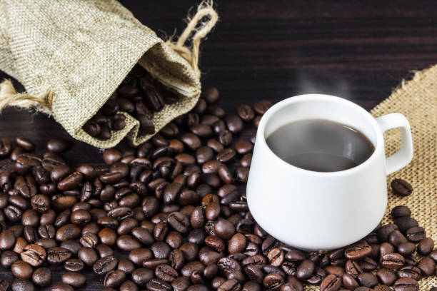 istock Close-Up Of Coffee Cup With Beans On Table 923765674