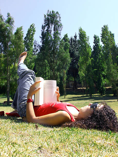 istock Woman reading book in park 92376909