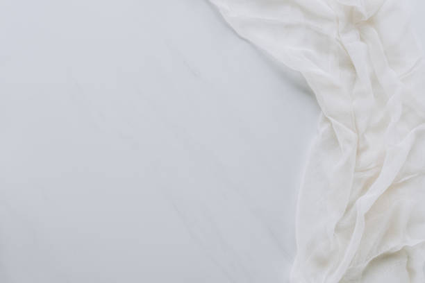 istock top view of white fabric and blank grey background 923771022