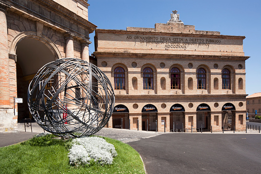 Macerata, Italy - The façade of Sferisterio open-air theatre. at Piazza Nazario Sauro with the restaured Sphere by Umberto Peschi