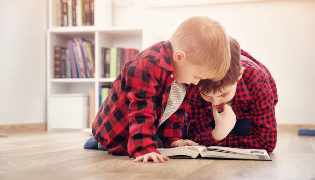 istock Three years old child sitting among books at home 923772546