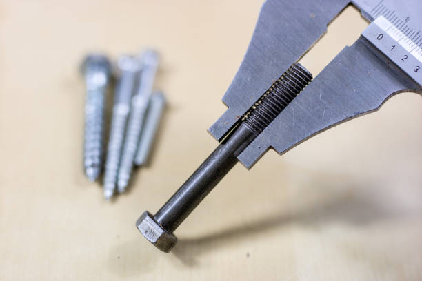 istock Tools and measuring accessories on a wooden workshop table. Performing control measurements using calipers, micrometers and other measuring accessories. 923772612