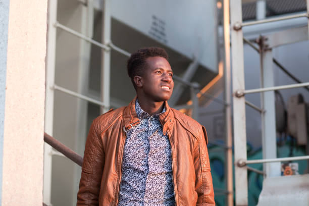 istock Handsome smiling young black man in industrial background 923772978