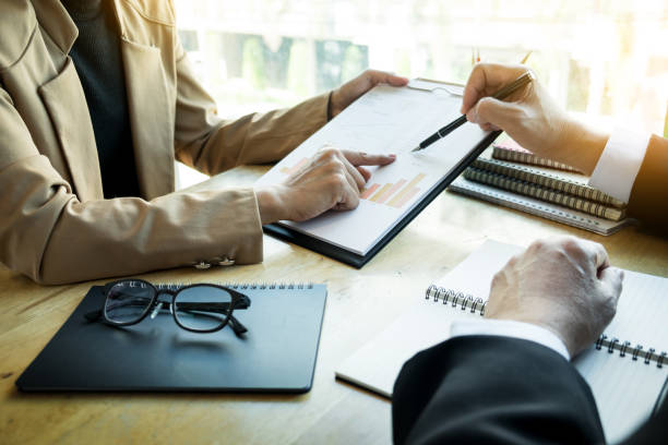 istock Close-Up Of Businessmen Working On Table At Office 923775516