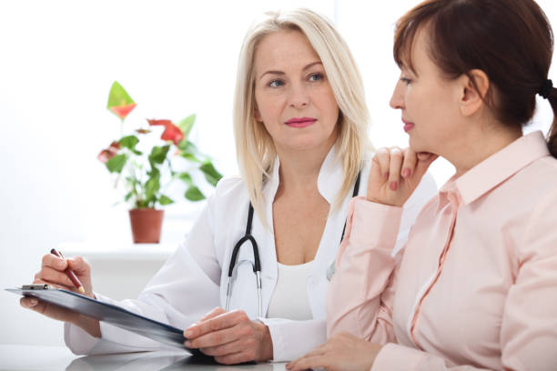 istock Female doctor holding application form while consulting patient 923782916