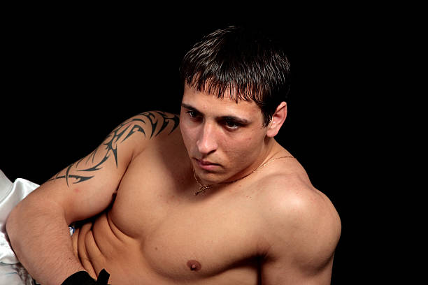 Portrait of a young man.  cross shoulder tattoos stock pictures, royalty-free photos & images