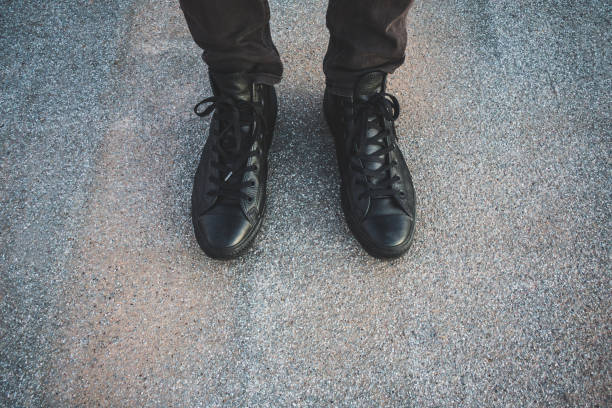 istock Low Section Of Man Standing On Footpath 923789684