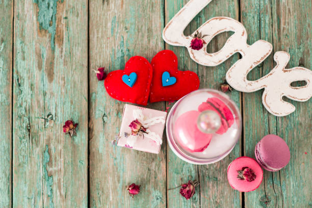 istock French macaroons cookies gift box and cappuccino cup on a wooden background. 923793344