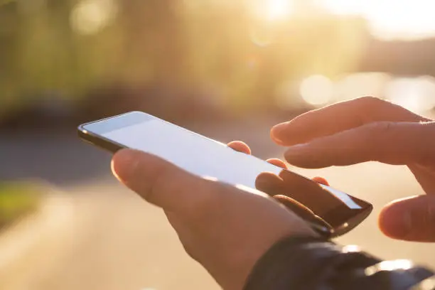 Photo of Man using his Mobile Phone outdoor