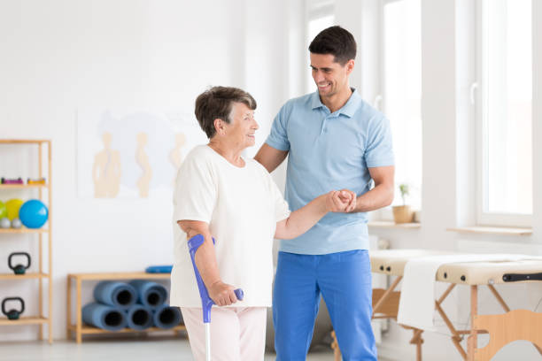 Disabled elderly woman with endoprosthesis Disabled elderly woman with endoprosthesis and smiling physiotherapist in rehabilitation center hip replacement stock pictures, royalty-free photos & images