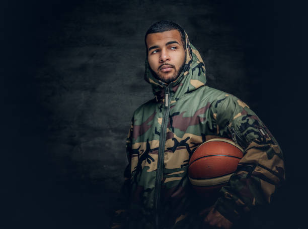 istock African American male holds basket ball. 923796402