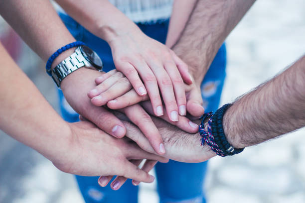istock Friends putting their hands together 923799918