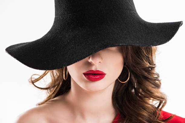 istock attractive woman hiding eyes under black hat isolated on white 923802620