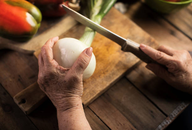 Senior woman chopping onion