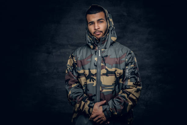 African American male dressed in a camouflage jacket.