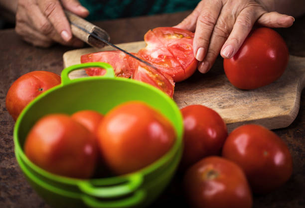 istock Senior woman chopping tomatoes 923805966
