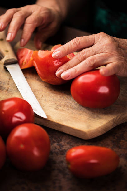 istock Senior woman chopping tomatoes 923806178