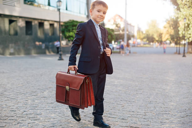 Future businessman in formal costume with briefcase stock photo