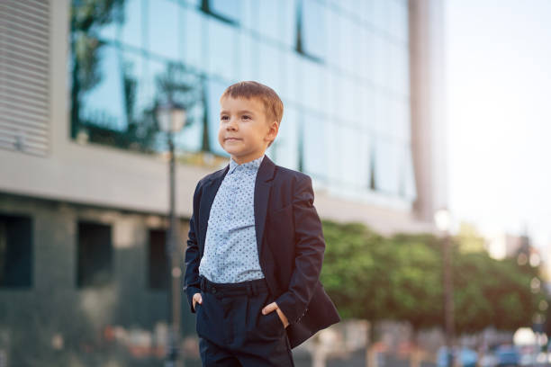 Boy in classic modern dark blue business costume stock photo