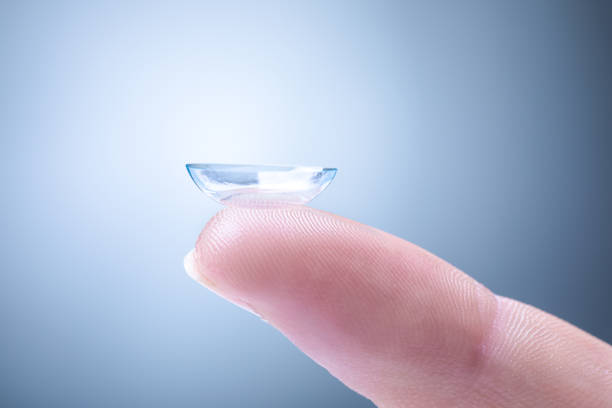 Contact Lens on a Finger Contact Lens on a Man's Index Finger contact lens photos stock pictures, royalty-free photos & images