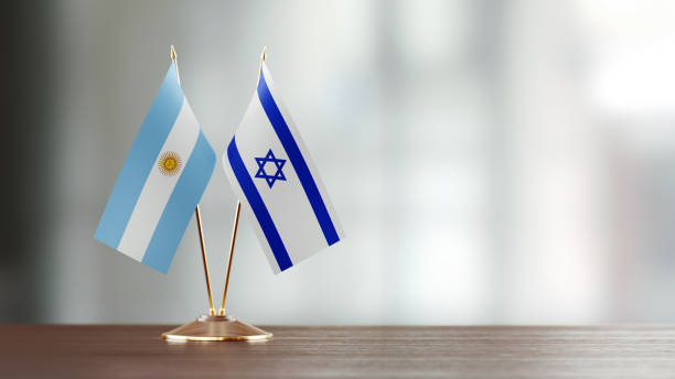 istock Argentinian And Israeli Flag Pair On A Desk Over Defocused Background 923809482