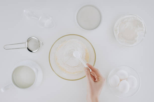 istock cropped shot of person preparing dough while cooking pancakes isolated on grey 923809782
