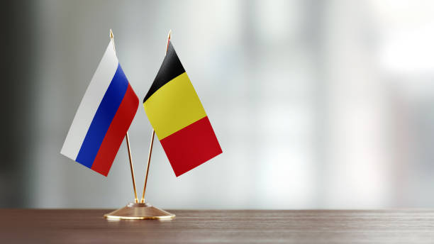 istock Belgian And Russian Flag Pair On A Desk Over Defocused Background 923812748