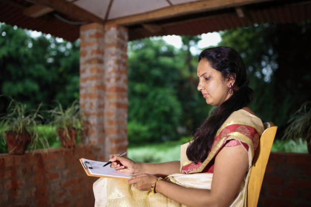 istock Hindu Woman Writing on Paper 923814244