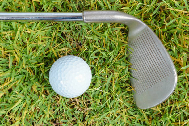 istock Golf clubs and golf ball on green grass background 923824366