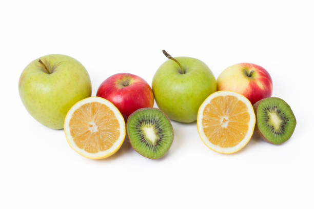 istock Fruits in a composition on a white background. Lemon with apples and kiwi on white background. Fruits with carrots on a white background. 923824416