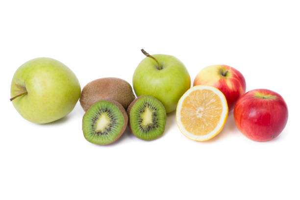 istock Fruits in a composition on a white background. Lemon with apples and kiwi on white background. Fruits with carrots on a white background. 923824420