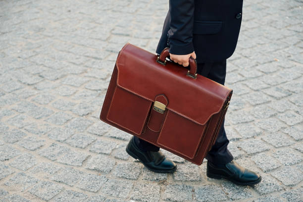 istock Hand holding business leather braun briefcase 923824466