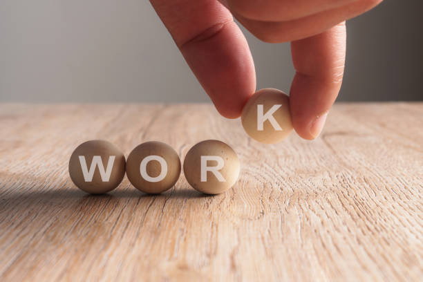 istock Hand putting on work word written in wooden ball 923826948
