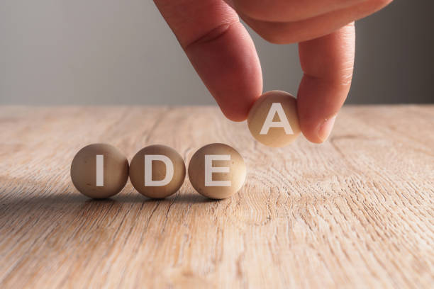 istock Hand putting on idea word written in wooden ball 923826982