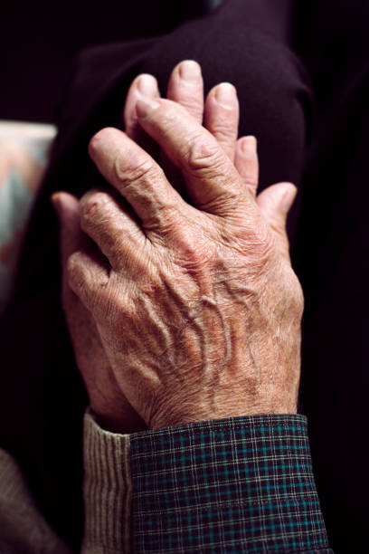 istock old man and old woman holding hands 923827788