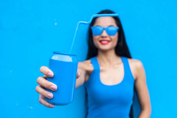 istock Woman in blue holding blue can 923831856
