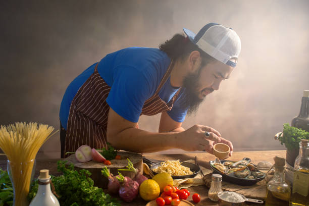 istock Man cook chef hipster with handsome bearded face in a hat 923835816