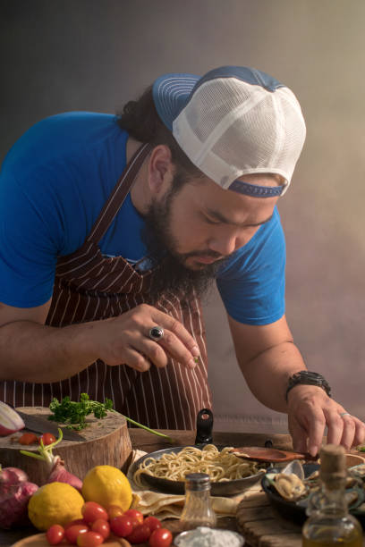 istock Man cook chef hipster with handsome bearded face in a hat 923835836