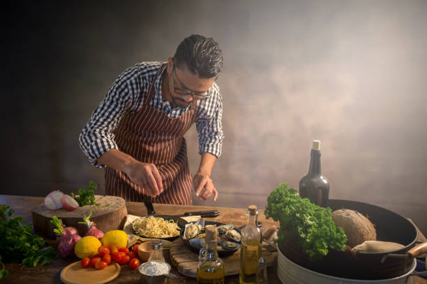 istock Man cook chef hipster with handsome bearded face in a hat 923835886