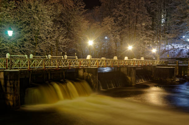 Ducks swim in the lake near the waterfall and take off from the surface of the water Autumn in the park Sports and recreation Lifestyle