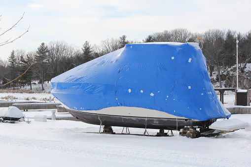 Plastic shrink wrap on boat, to protect boat and interior of boat from the winter elements.
